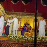Sri Palani Convention Center wedding hall with elegant stage decor, chandeliers, and banquet seating in Hyderabad